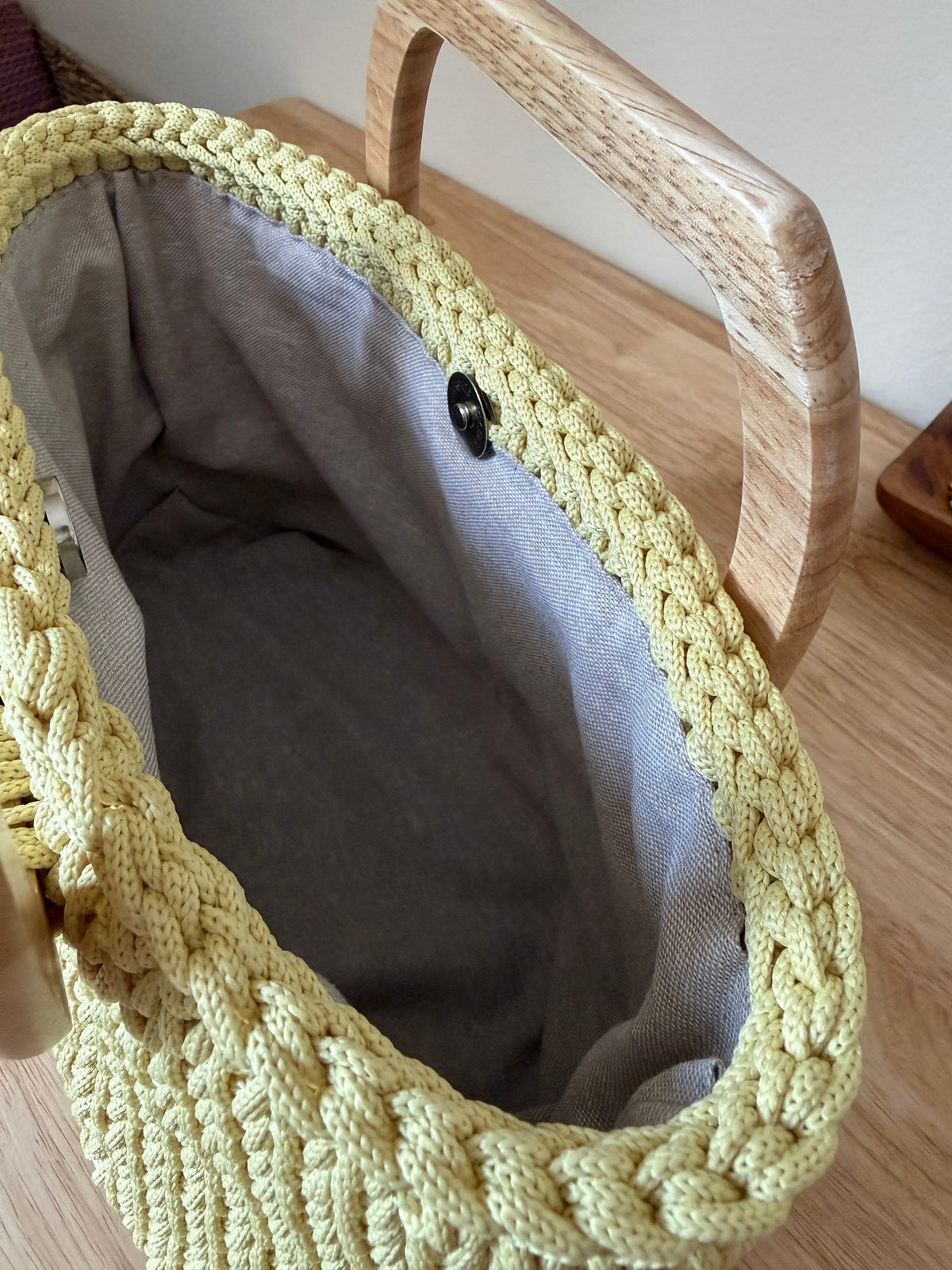 Handbag with wooden handles in light yellow color